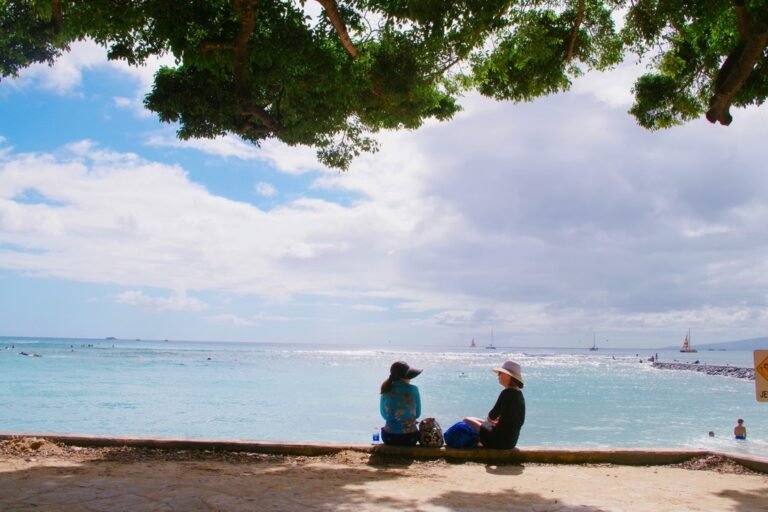 Two women chatting in front of the sea